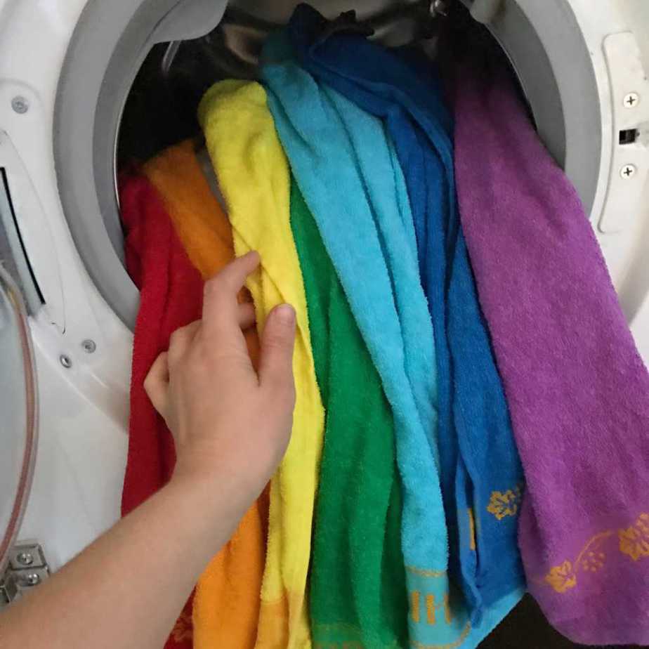 Image of putting clothes in washing machine