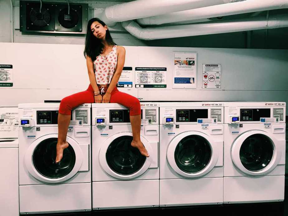 Image of a girl sitting on washing machine